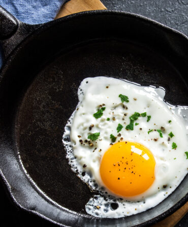 A fried egg in a cast iron skillet