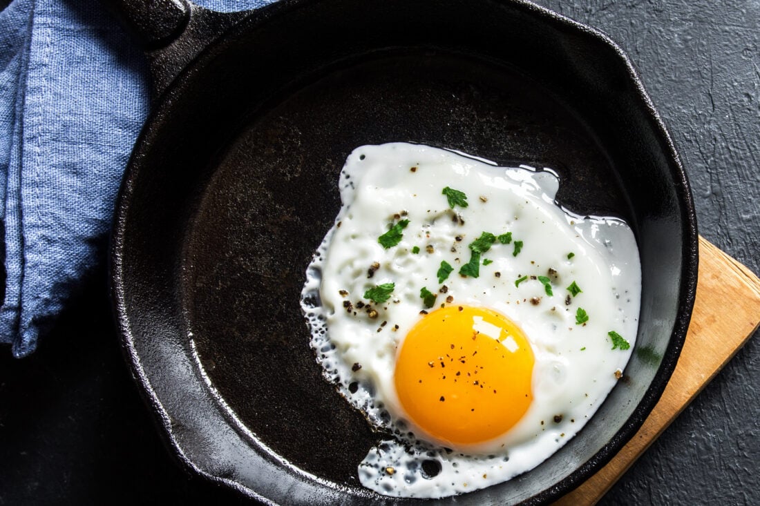 A fried egg in a cast iron skillet