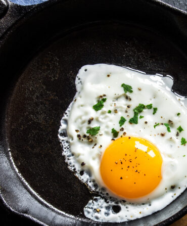 A fried egg in a cast iron skillet