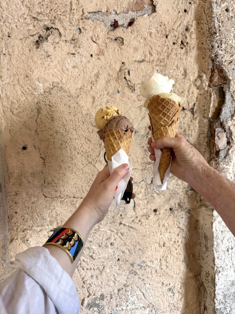 Two hands hold ice cream cones