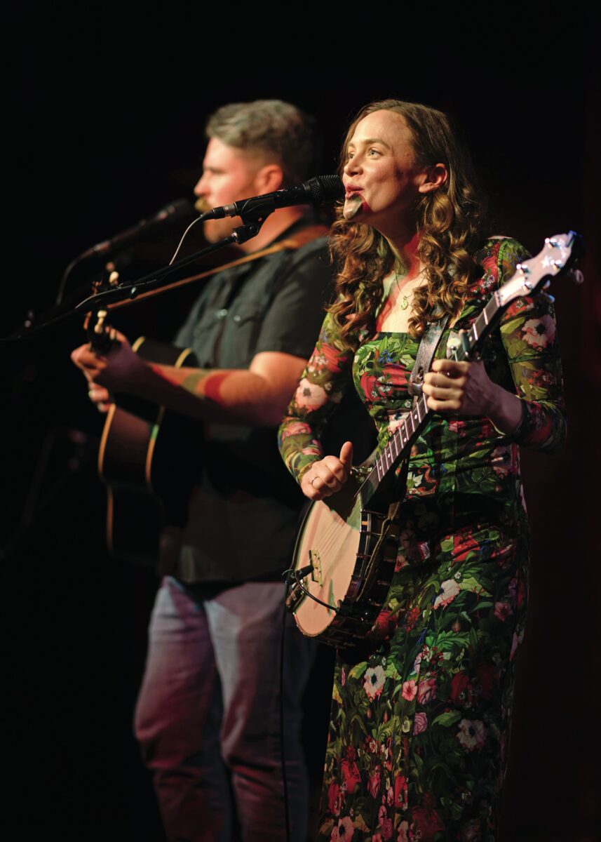 A woman sings on a stage