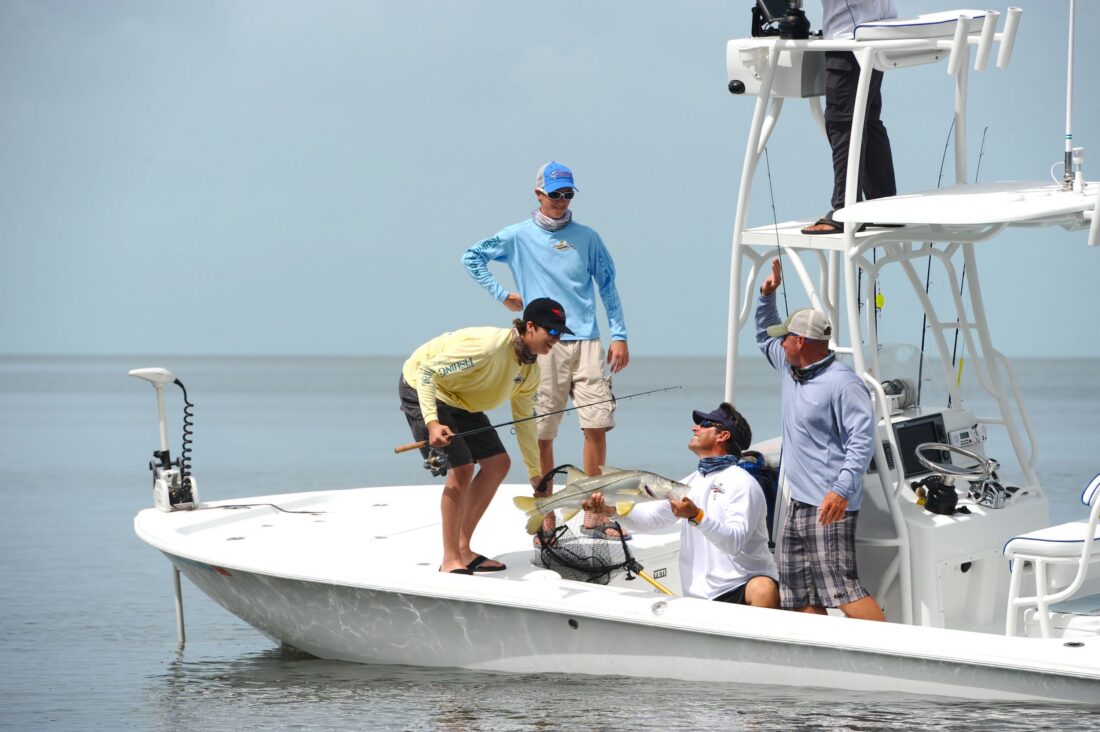 People in a boat catch a fish