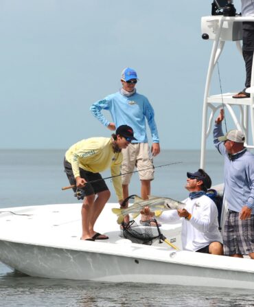 People in a boat catch a fish