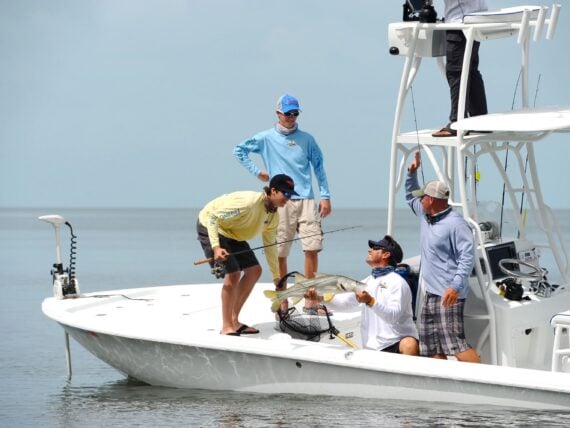 People in a boat catch a fish