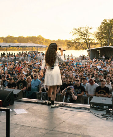 A woman performs on a stage