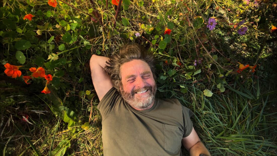 Zach Galifianakis among nasturtium flowers.