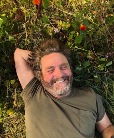 Zach Galifianakis among nasturtium flowers.