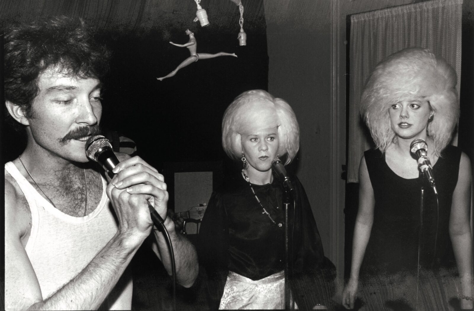 A vintage photo of three people at a party