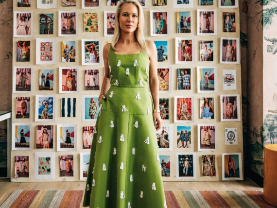 Hunter Bell standing in her office in front of a moodboard.