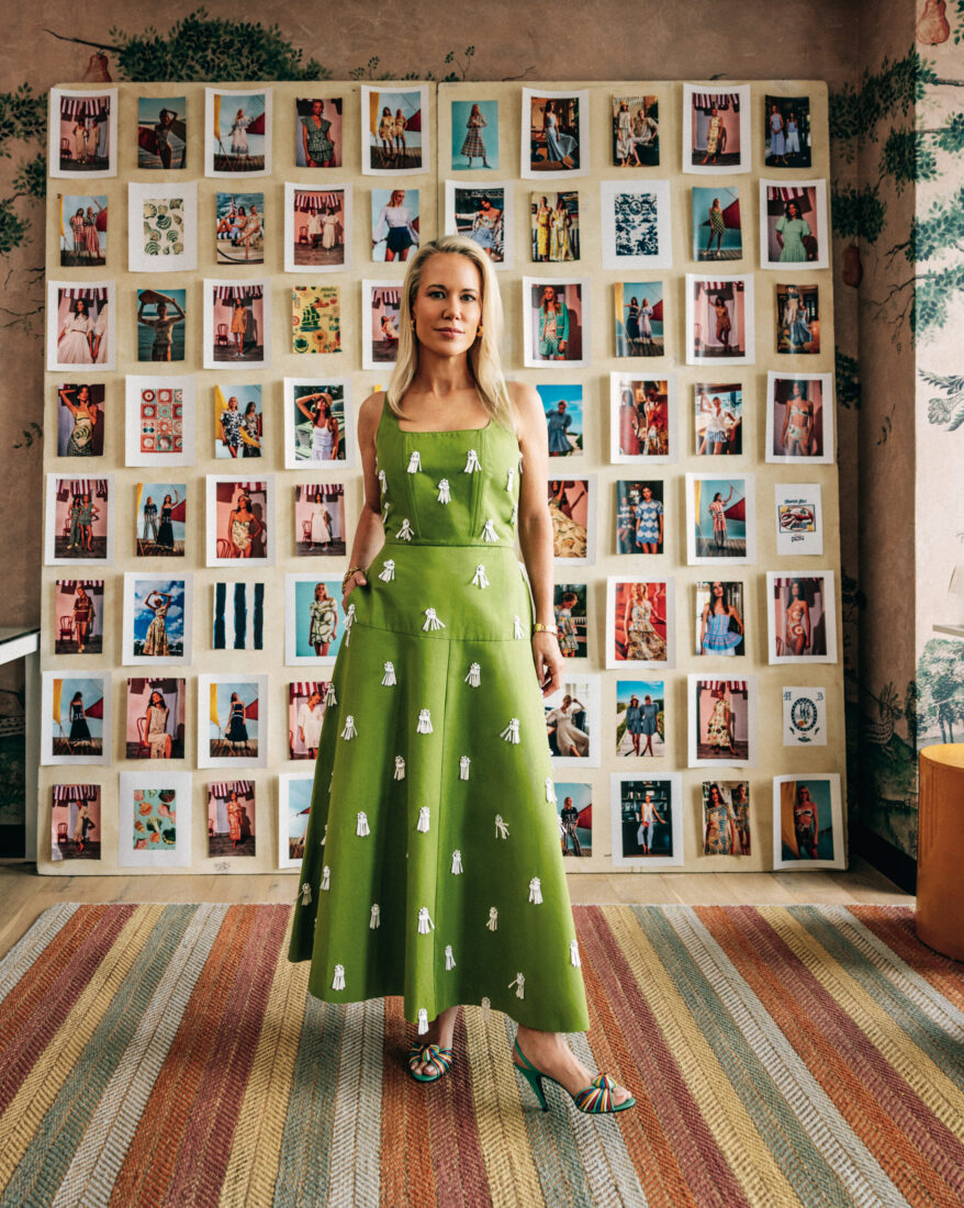 Hunter Bell standing in her office in front of a moodboard.