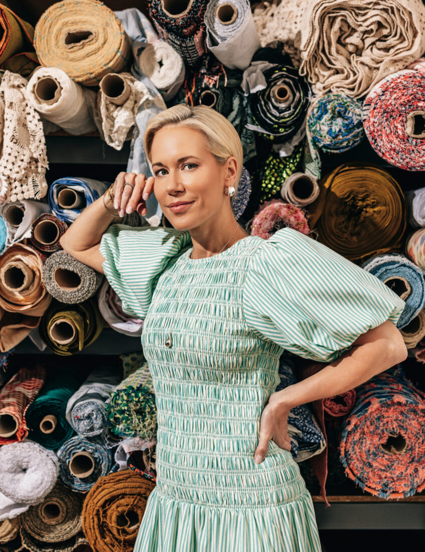 A woman with bolts of fabric