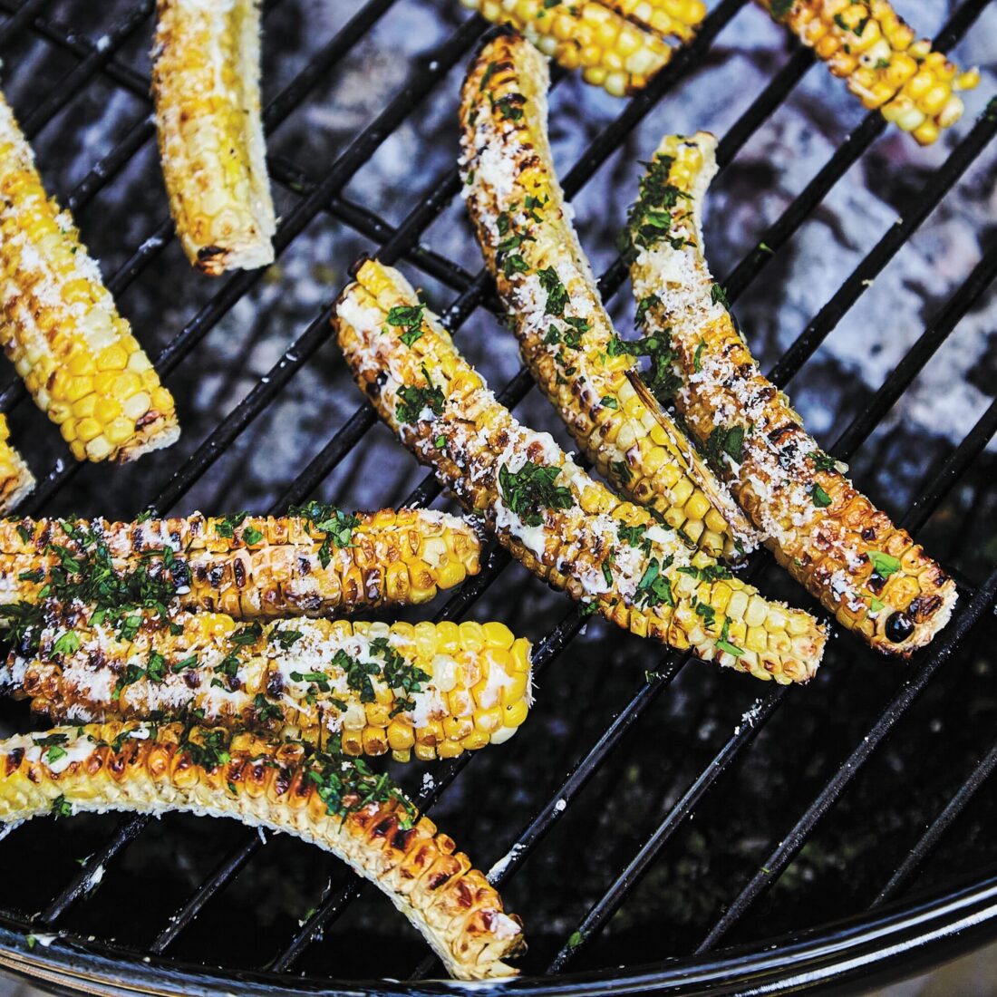 ribs of corn charred on a grill
