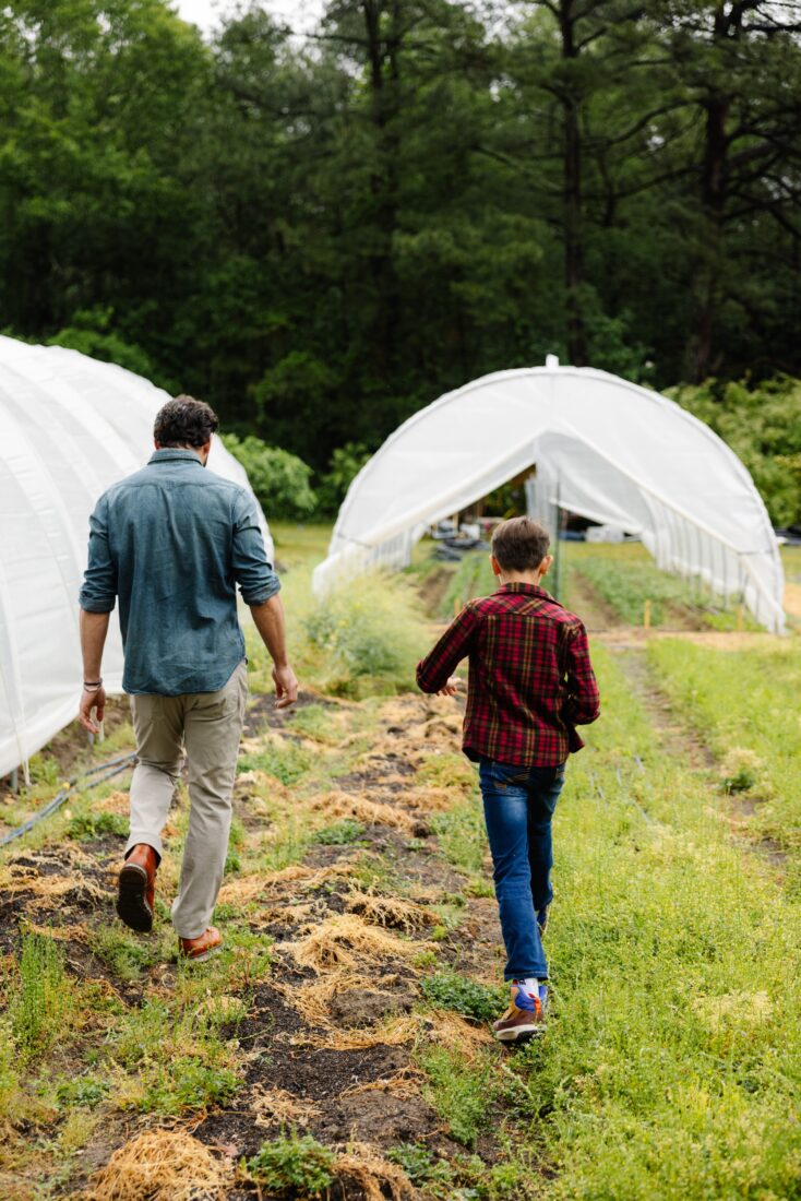 image of a father and son walking next to one another at a farm