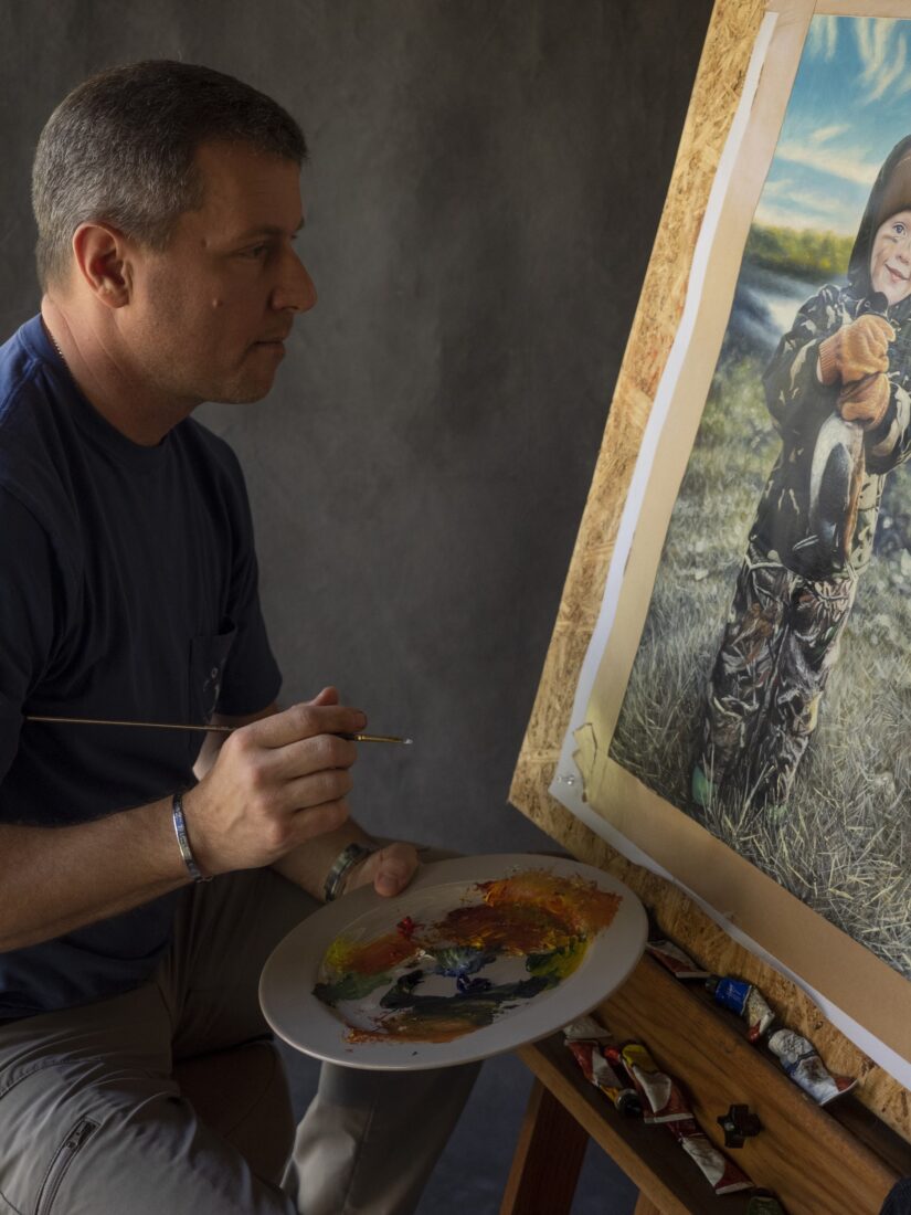 A man paints at an easel