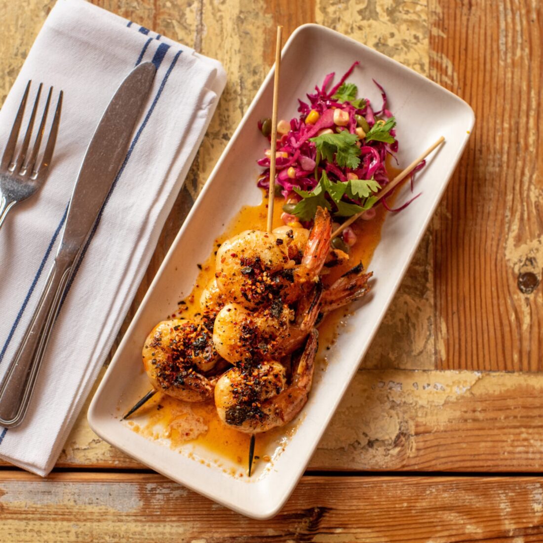 shrimp kebabs with kimchi butter on a plate