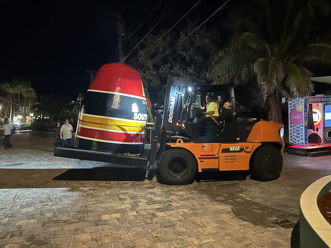 Workers install a buoy on a street