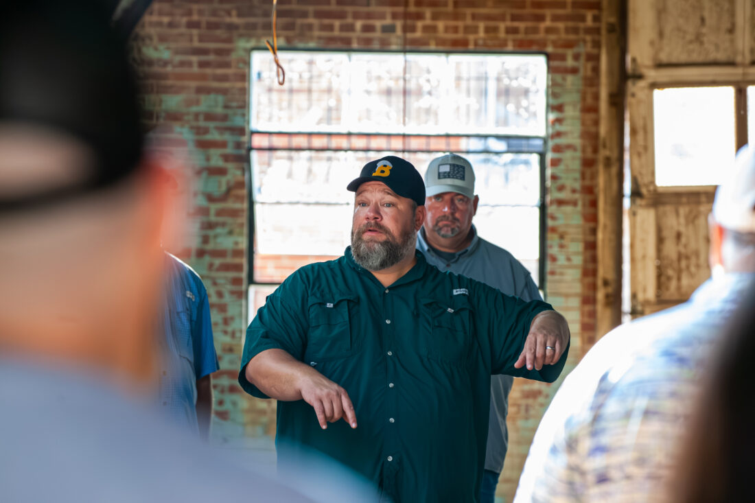 A man speaks at a distillery