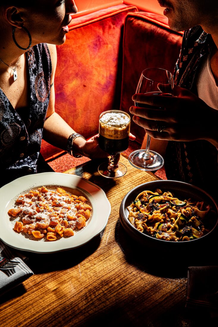 Pasta dishes and cocktails on a table