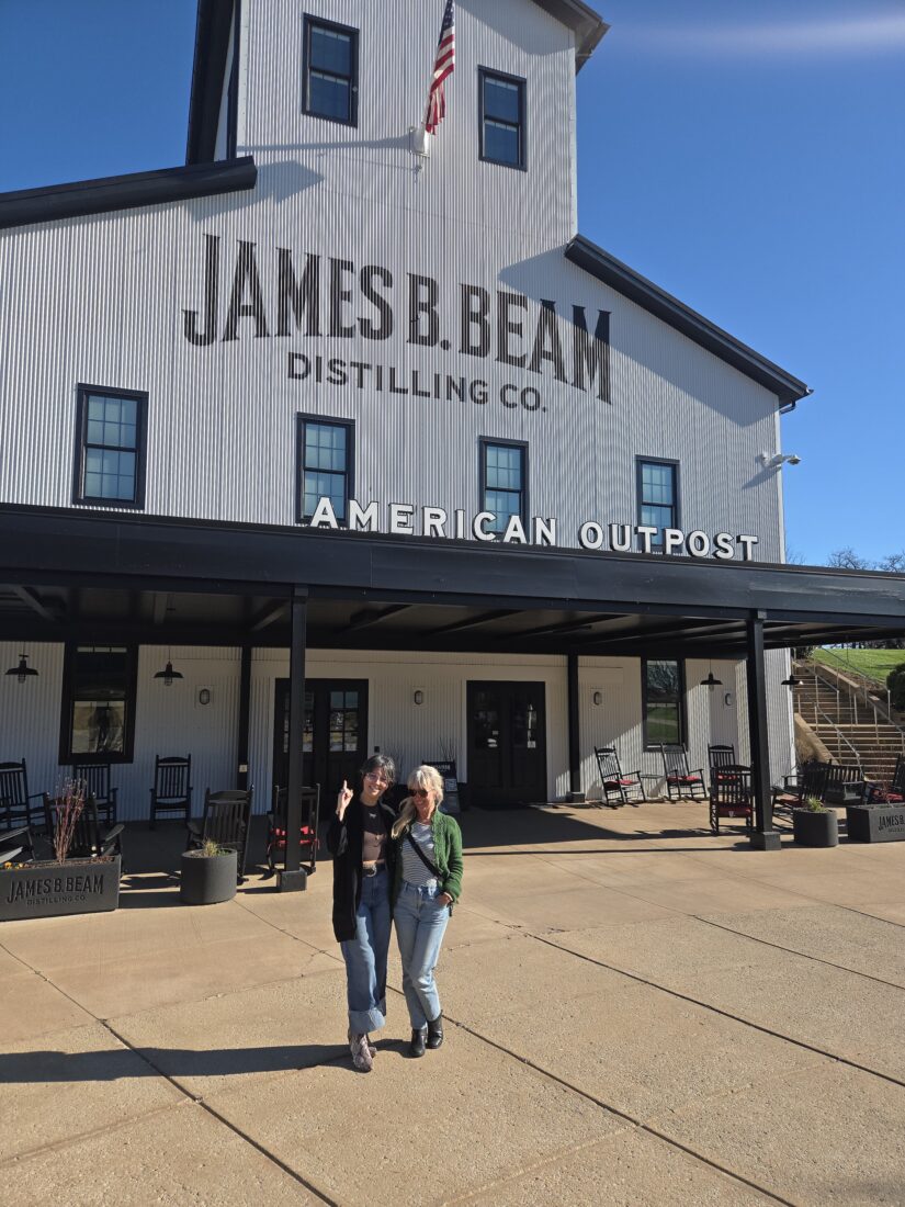 Two women outside a distillery