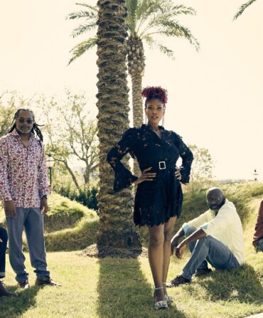 image of the band, Ranky Tanky, posing for a photo in a field