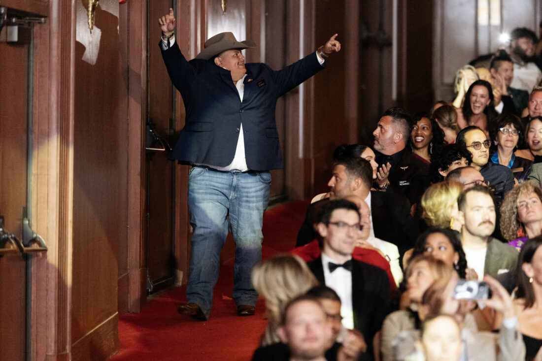 A man walks down an aisle