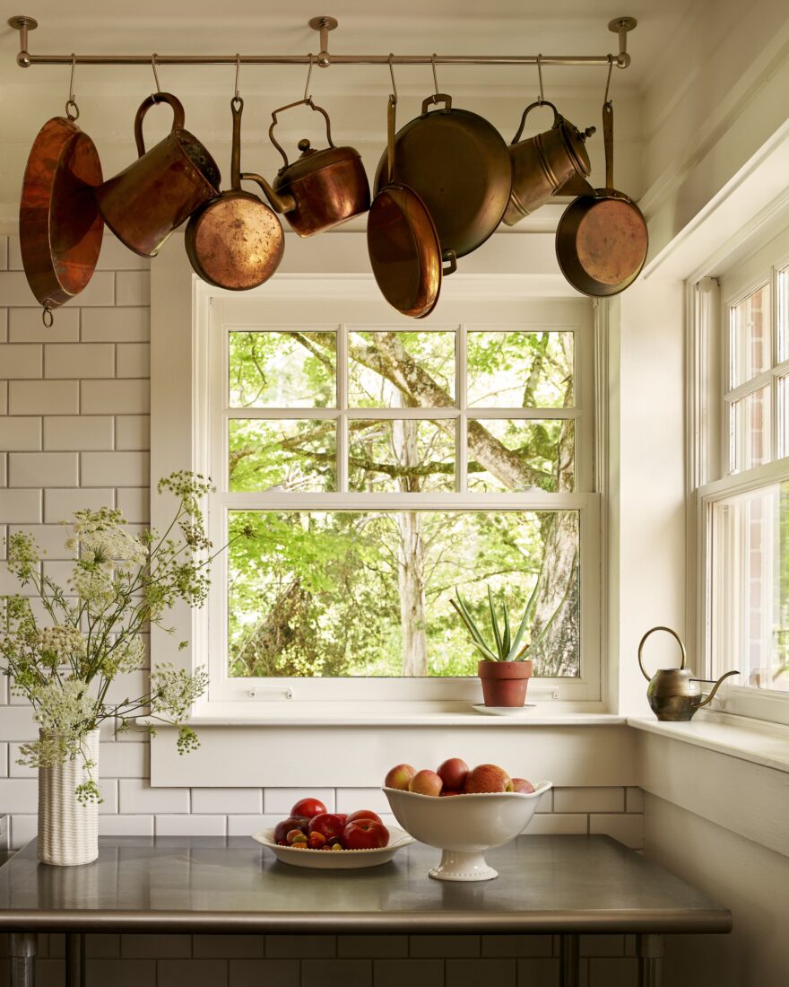 image of copper pots hanging above a window