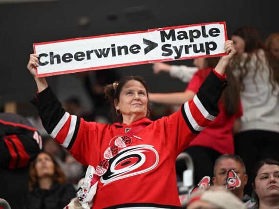 image of a hockey fan holding up a banner