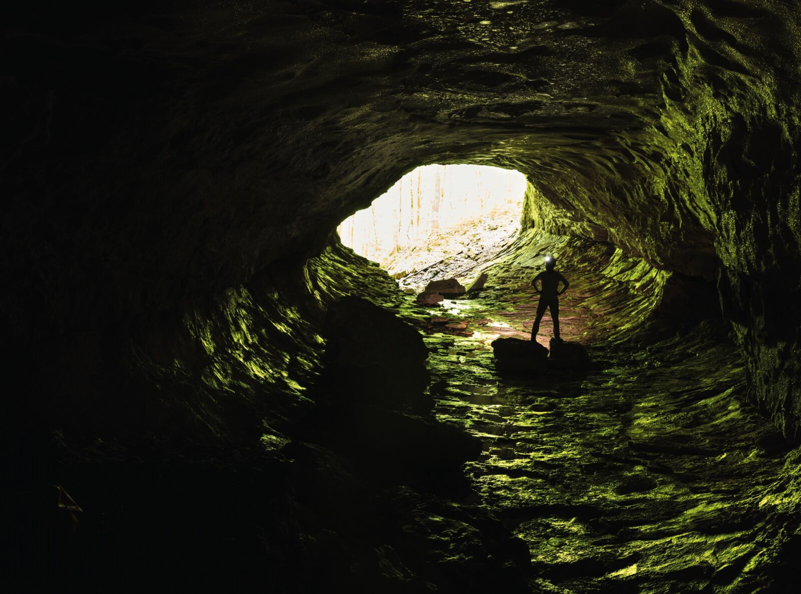A man stands inside a cave