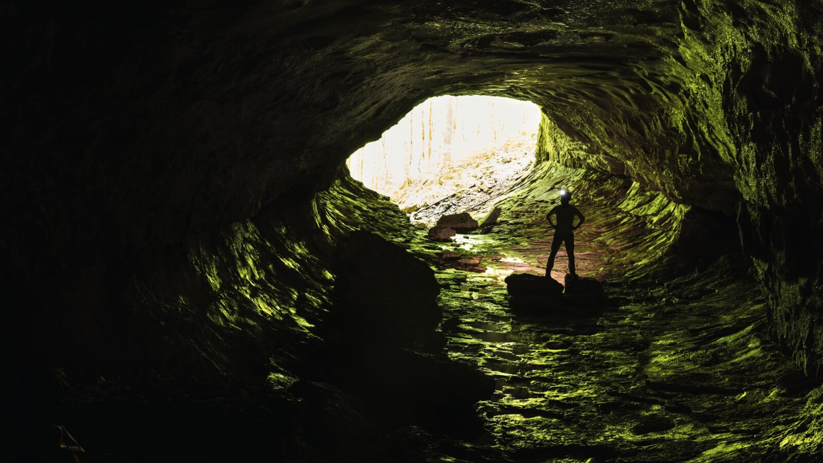 A man stands inside a cave