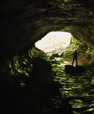 A man stands inside a cave
