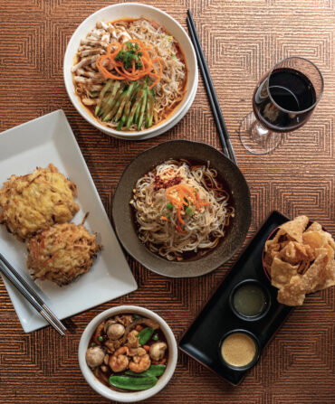 Clockwise from top: Royal China’s chicken noodles in peanut sauce, Dan Dan Mian, wonton chips and dips, and egg foo yong with a shrimp-and-vegetable gravy.