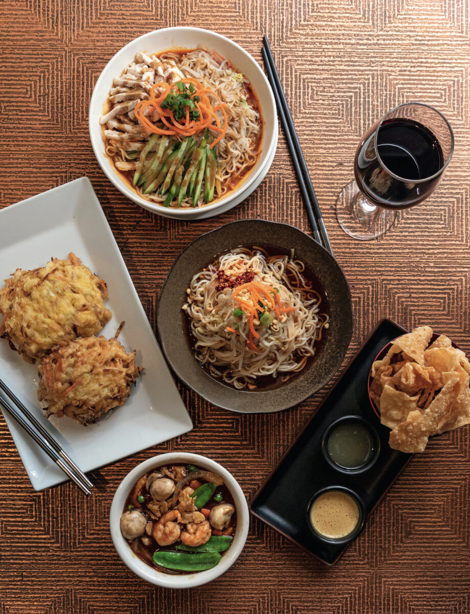 Clockwise from top: Royal China’s chicken noodles in peanut sauce, Dan Dan Mian, wonton chips and dips, and egg foo yong with a shrimp-and-vegetable gravy.