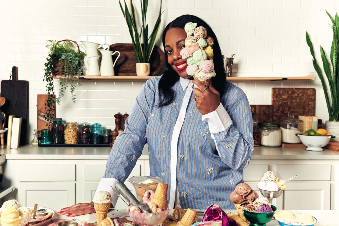 A woman holds a cone of ice cream
