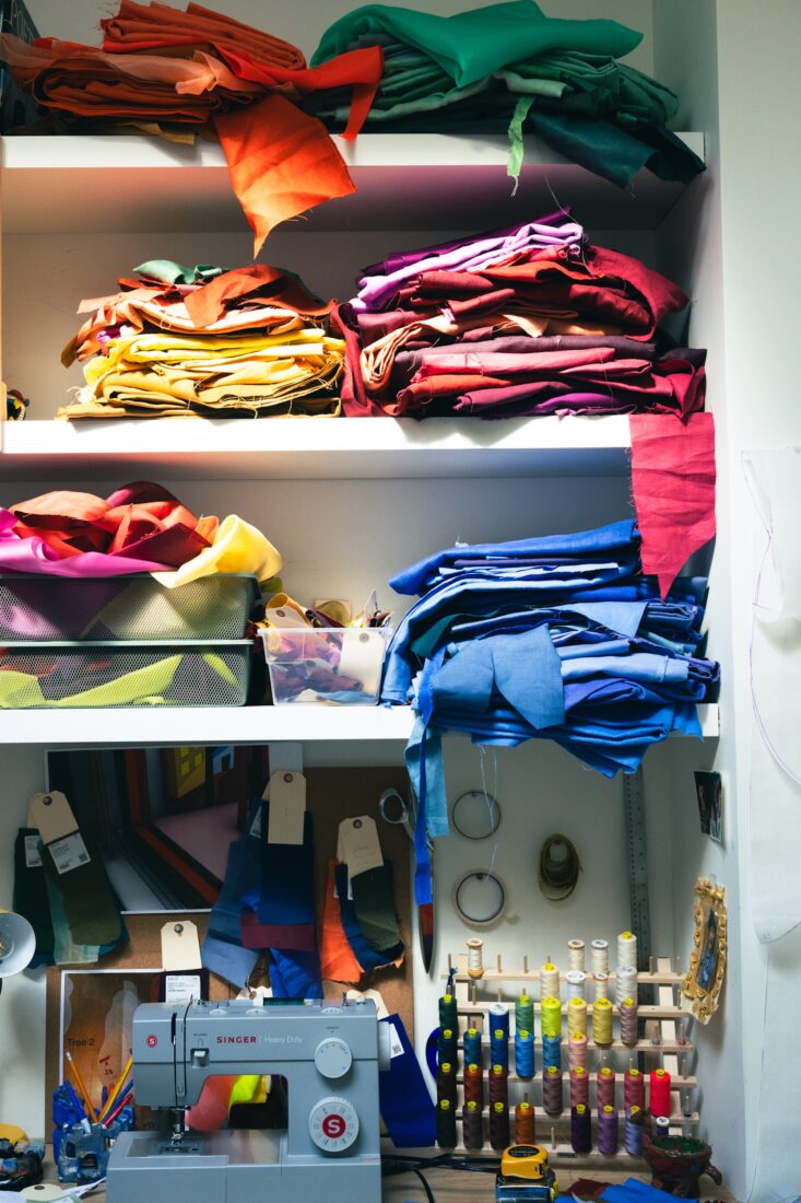 A rainbow of fabrics and thread in a closet