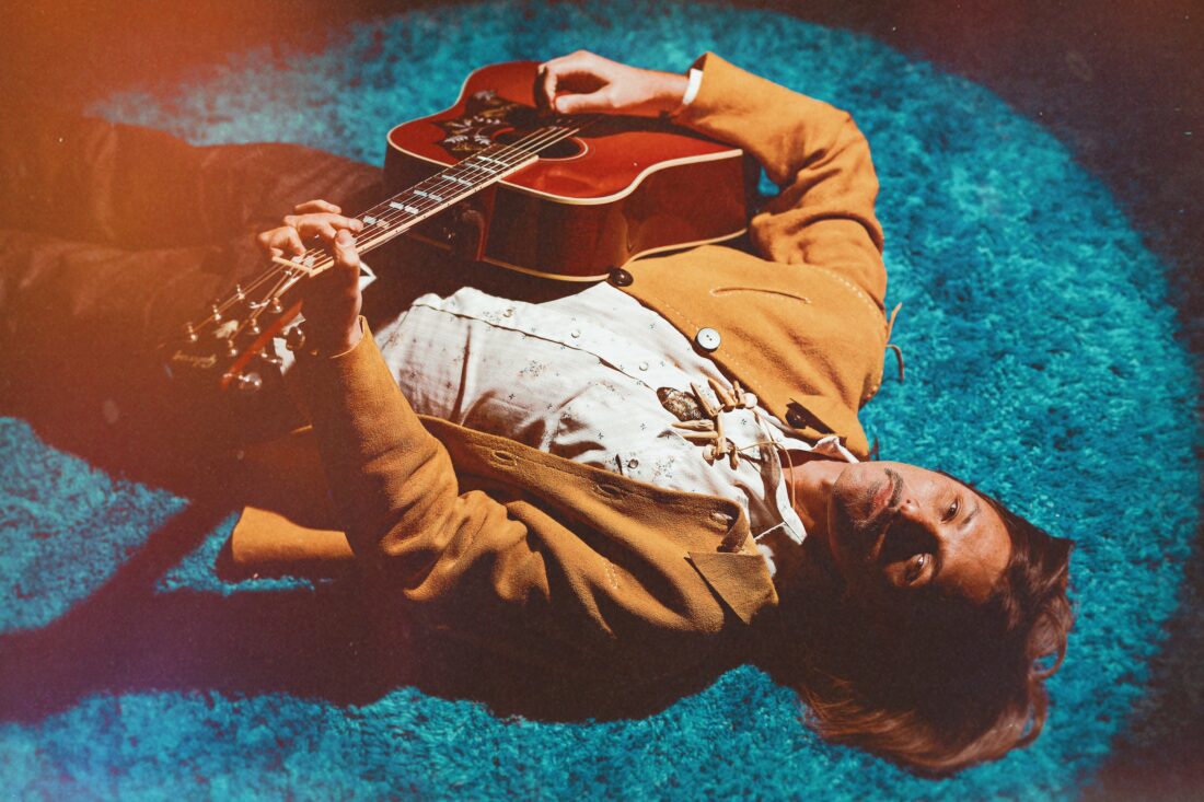 A portrait of a man with a guitar