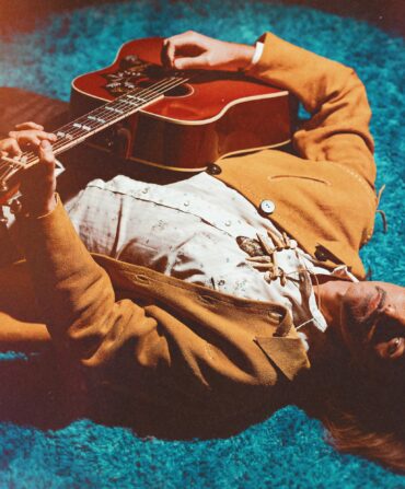 A portrait of a man with a guitar