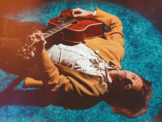 A portrait of a man with a guitar