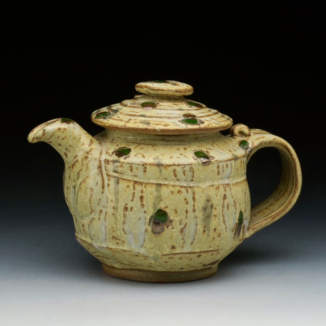 image of a yellow tea pot pottery piece