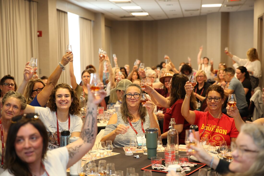 Women toast with bourbon