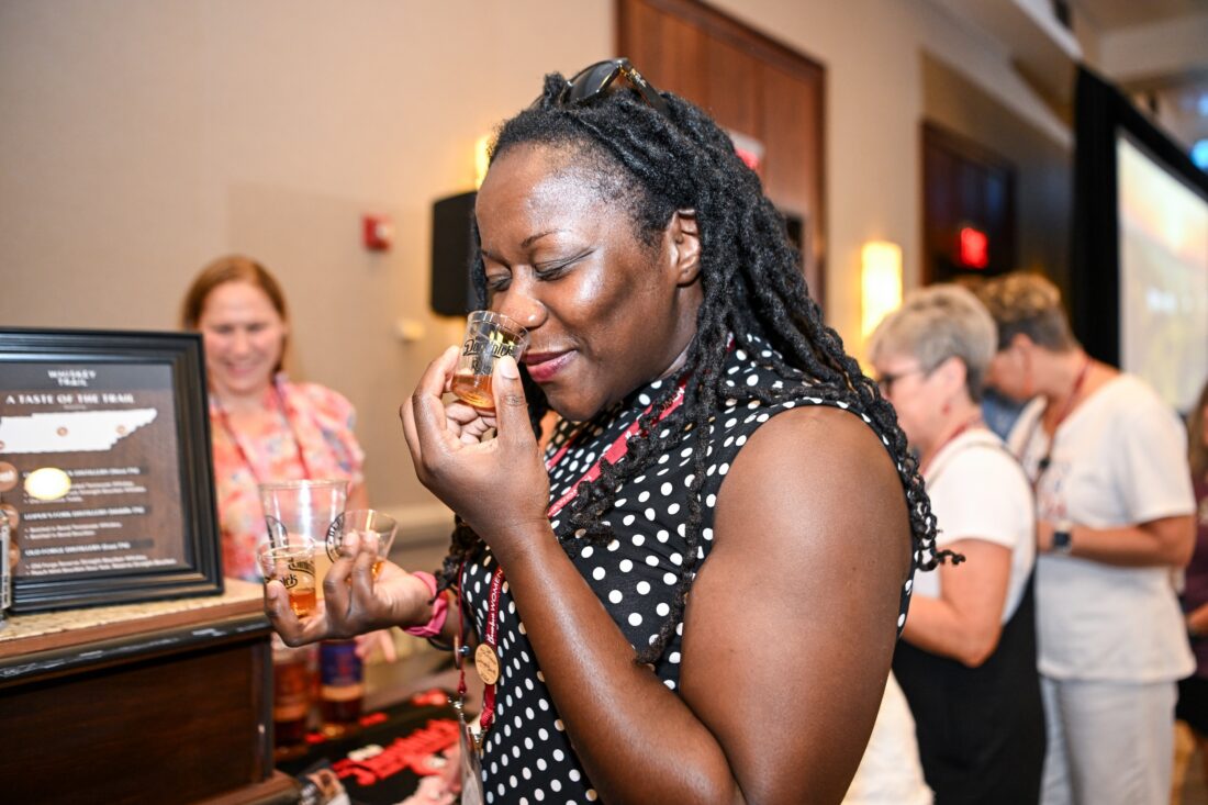 A woman noses a bourbon sample