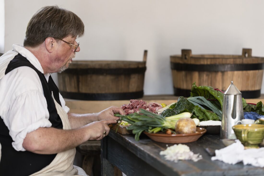 A man at a kitchen table with food