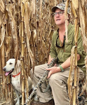 A man with a dog in the field