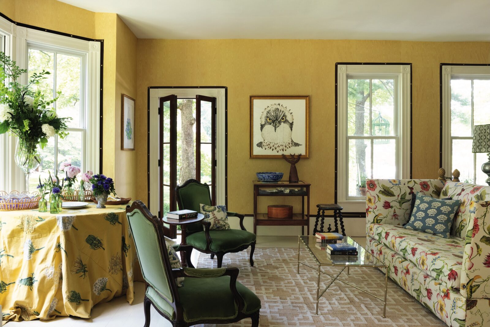 A yellow living room with a drawing of an osprey