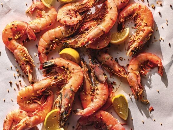 Cooked shrimp with lemon on a white background
