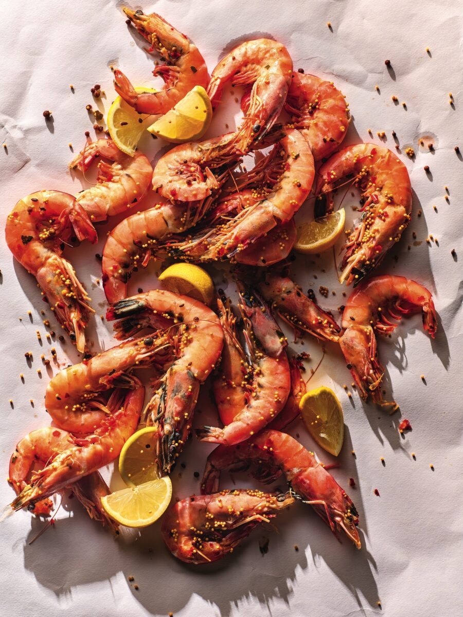Cooked shrimp with lemon on a white background