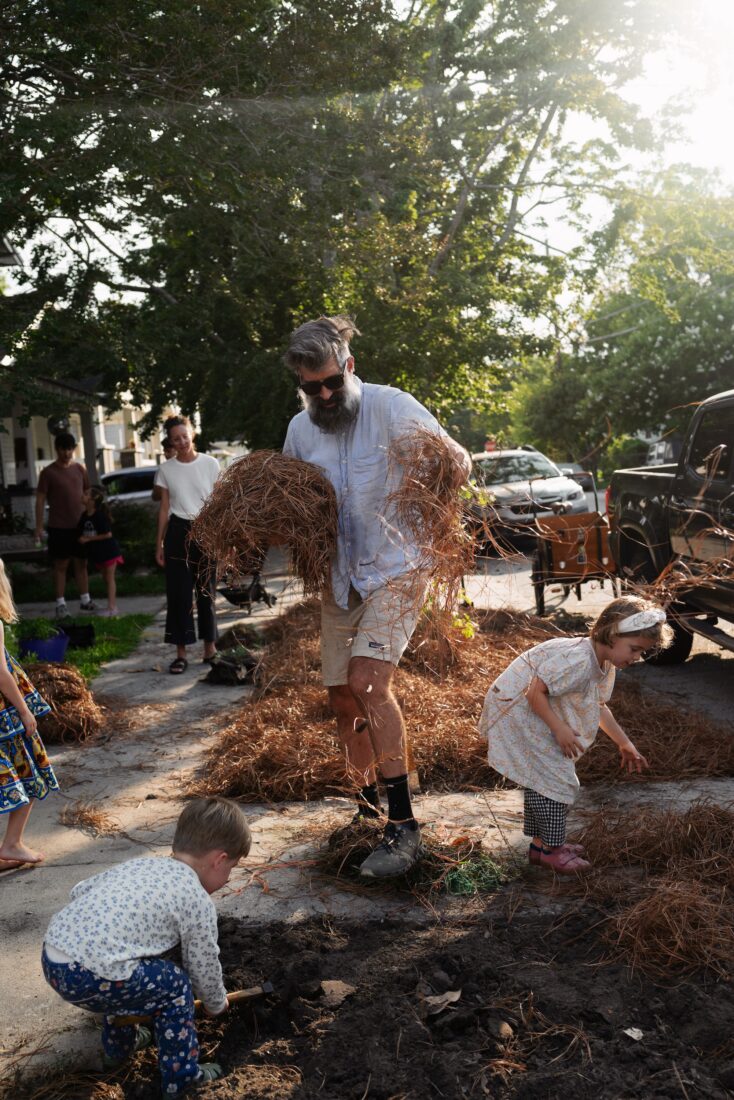 A man holds pine straw
