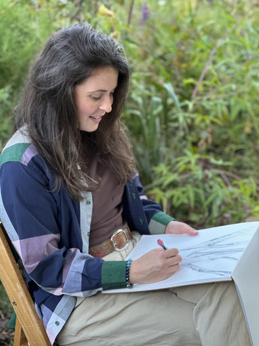 A woman draws outside