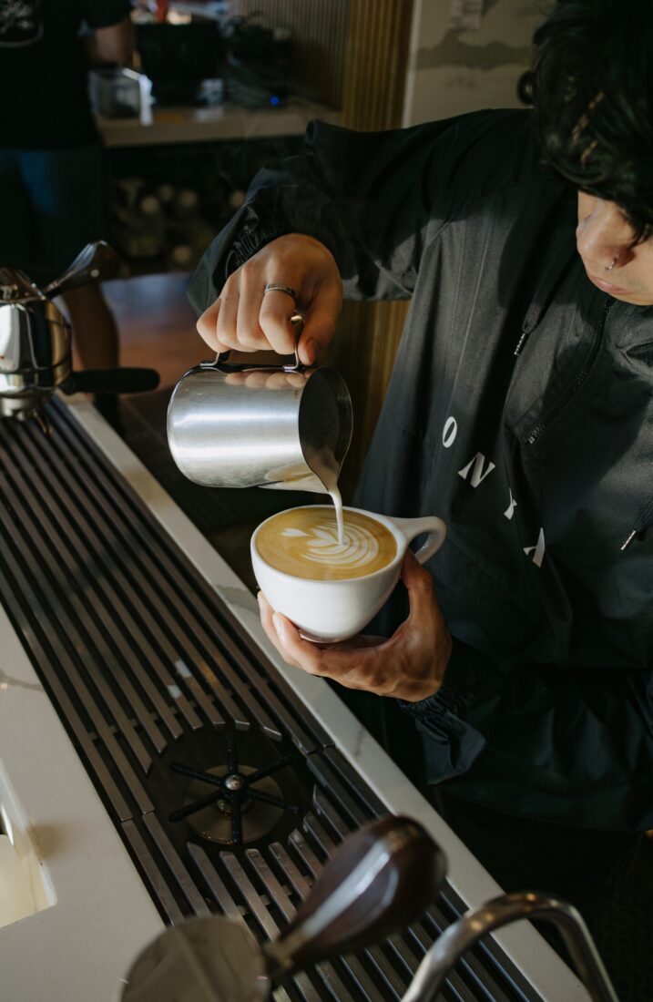 A person makes a latte