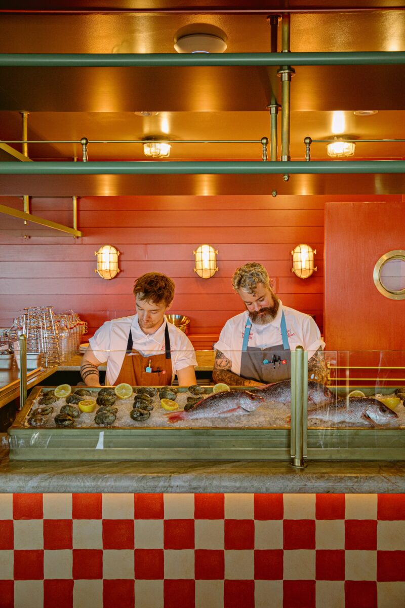 Two chefs at a raw bar