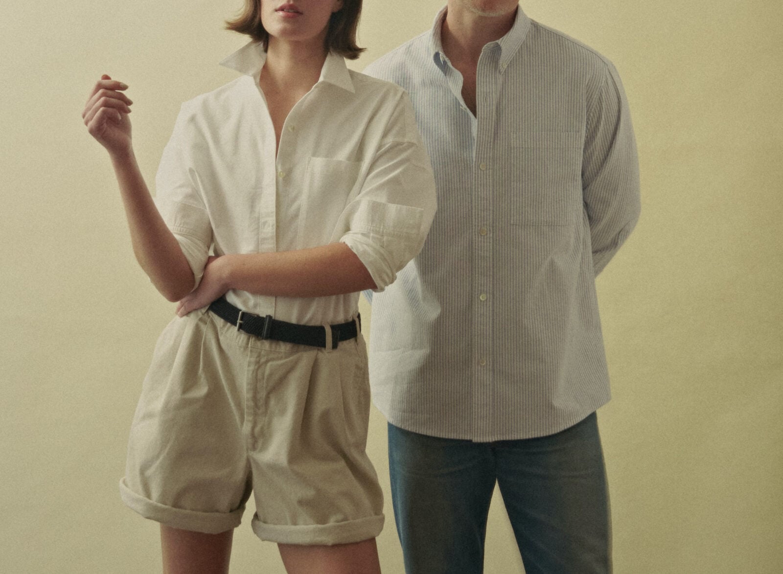 A man and woman in Oxford shirts